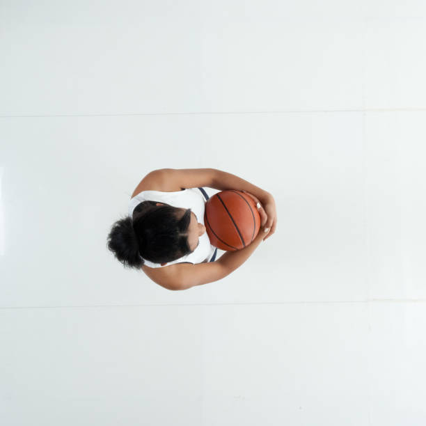directly above view / aerial view / full length / one person of 20-29 years old adult beautiful african ethnicity / african-american ethnicity female / young women basketball player / athlete / sportsperson standing / exercising and using sports ball - 11305 imagens e fotografias de stock