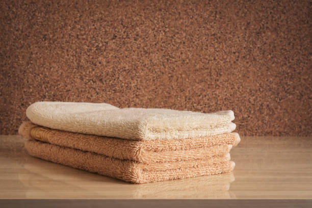 istock A stack of beige terry towels on a chest of drawers. Selective focus. 1188442784