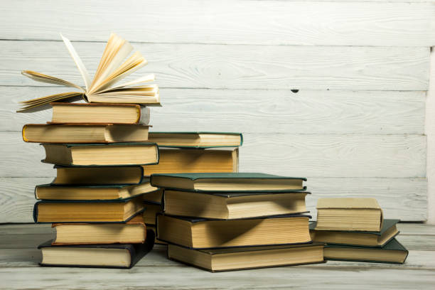 istock Open book, hardback books on wooden table. Back to school. Copy space 1188442842