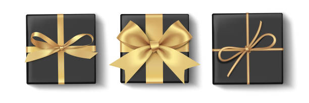 istock Set of decorative black boxes with golden bow isolated on white 1188444435