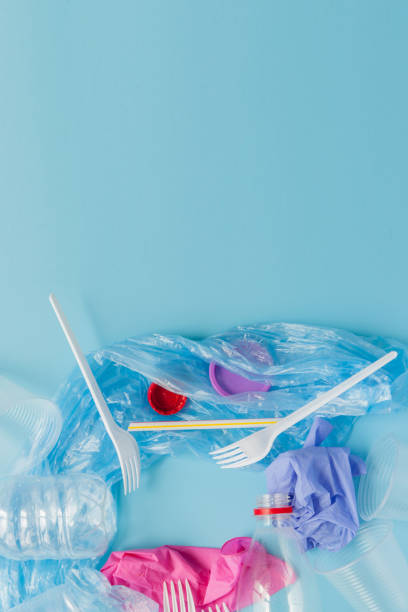 istock Top view of various kinds of disposable plastic waste on blue background, copy space 1188445840