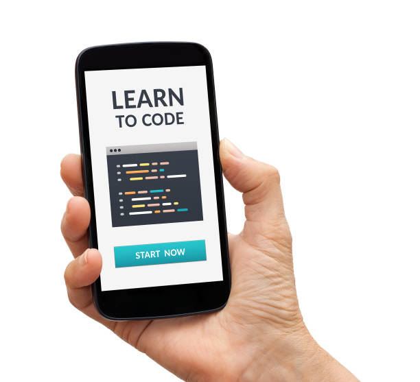 Hand holding smart phone with learn to code concept on screen stock photo