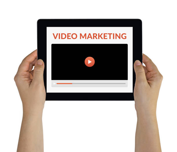 istock Hands holding tablet with video marketing concept on screen 1188446332