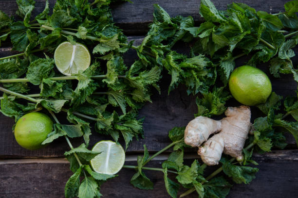 istock Lime fruit and mint leaves on wooden background. top view 1188446381