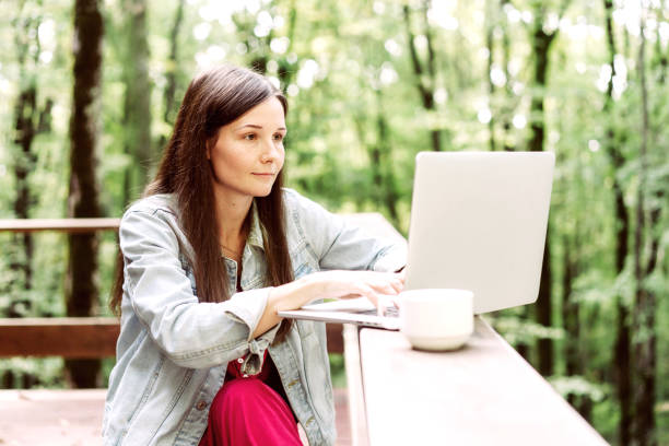 istock Female entrepreneur with laptop outside in fall day. 1188446473