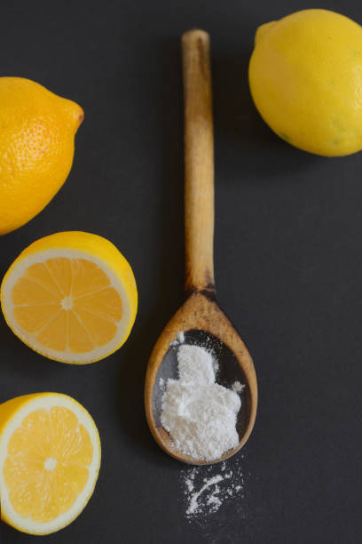 istock Lemon and baking soda on black background 1188447617