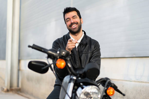 istock Young man on a motorbike pointing to the front 1188449390