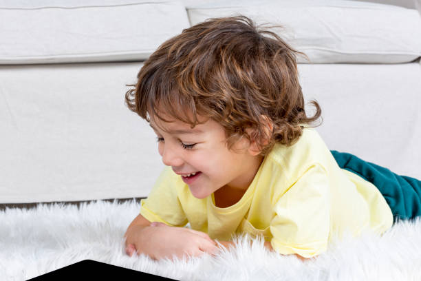 istock Little Boy working tablet on carpet 1188449417