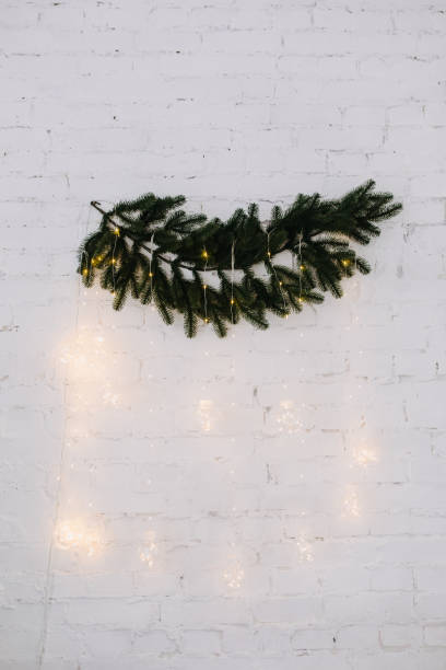 istock Garland Glowing Lamps Hanging from Fir-tree Branch 1188449647