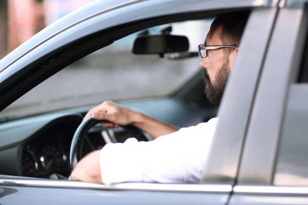 istock close up.handsome man sitting in a car. 1188452318