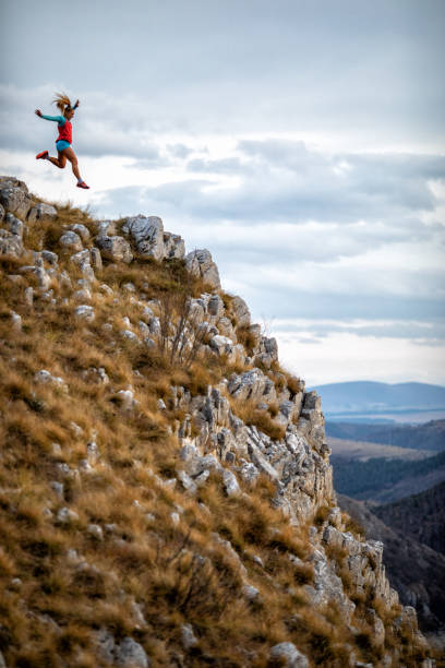 istock Young woman running on mountain 1188452403