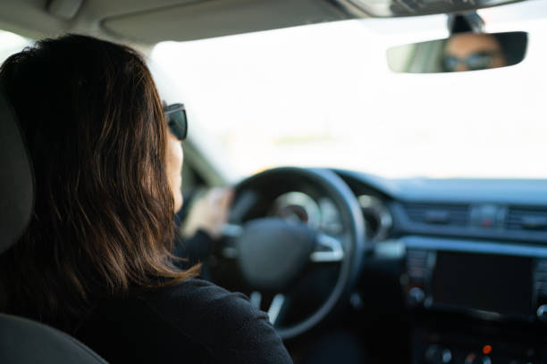 istock Young woman driving a car on a highway 1188452627