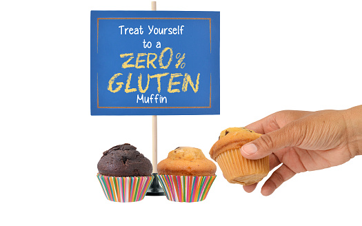 Zero Percent Gluten Muffins in front of blue sign white background