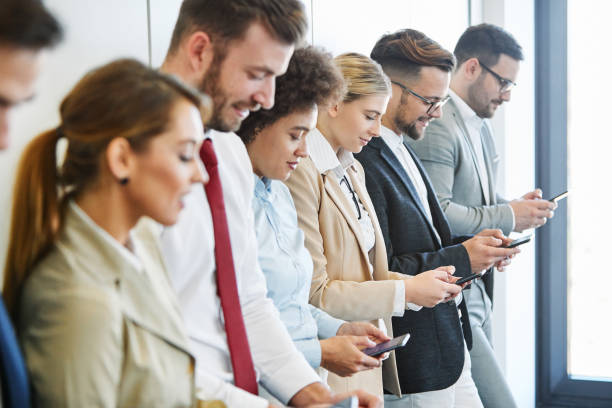 istock young business people team with mobile phone smartphone social 1188452784