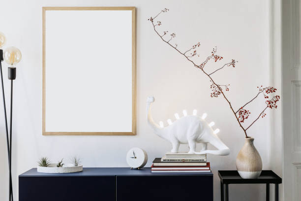 istock Stylish scandinavian living room with mock up photo frame, navy blue commode, table lamp and elegant accessories. Modern home decor. Interior design. Template Ready to use. 1188452855