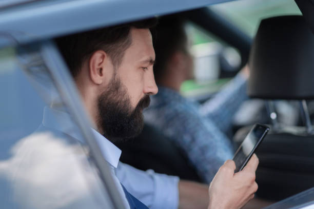 istock close up.businessman reading SMS on his smartphone 1188453849