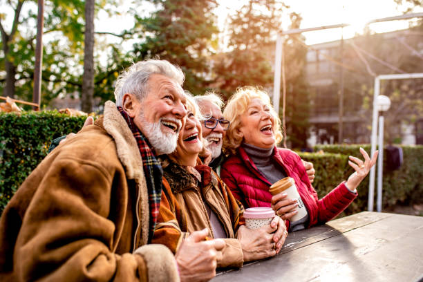 Happy seniors in the park take a break from walking