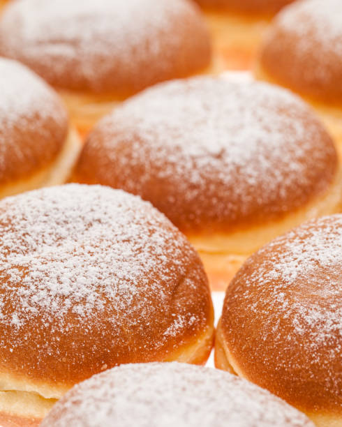 istock background of many Krapfen topped with icing sugar side by  side together 1188455370