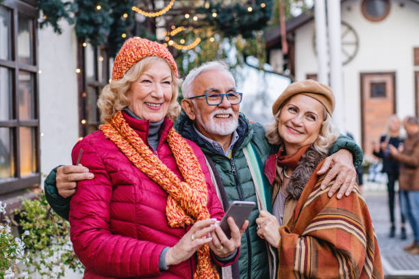 istock Group of seniors outdoors using phone 1188455466