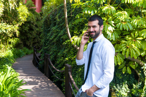 istock Businessman talking to mobile outdoor 1188455874