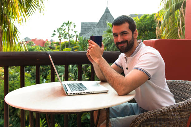 istock man working with his laptop on a hotel terrace 1188457134