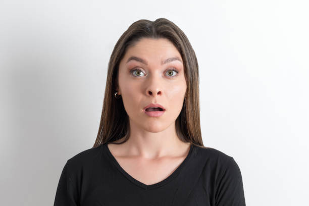 A Young slim woman is taken aback by something. Fear concept.