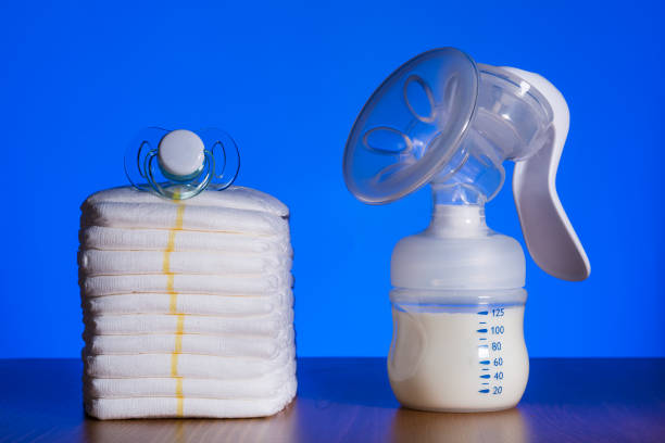 istock breast pump and diapers on a blue background 1188459005