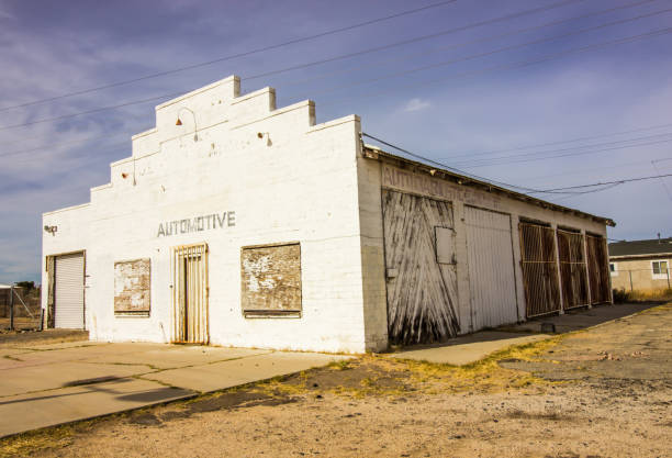 istock Abandoned Garage Building With Boarded Up Windows 1188459047