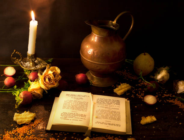 istock A prayer book and a candle on a dark table. 1188460232