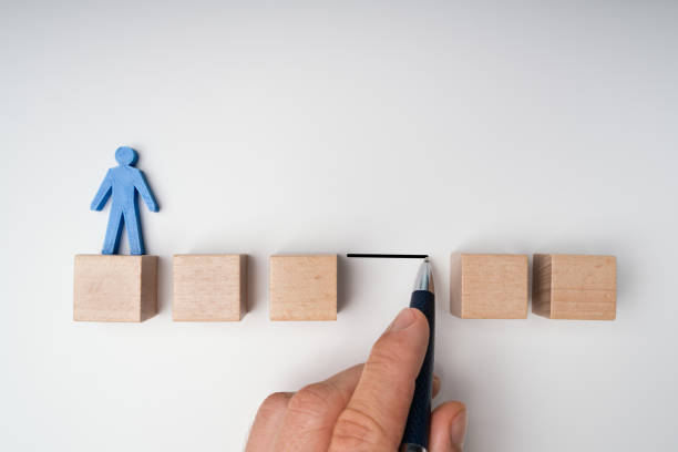 istock Human Hand Filling Gap Between Wooden Blocks 1188462237