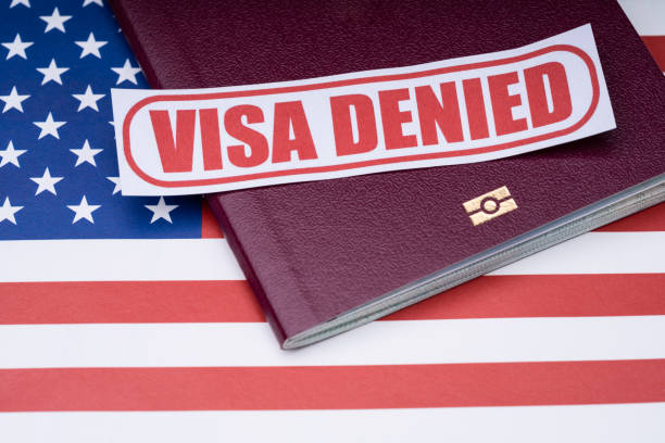 istock Visa Denied Text And Passport Over American Flag 1188462441