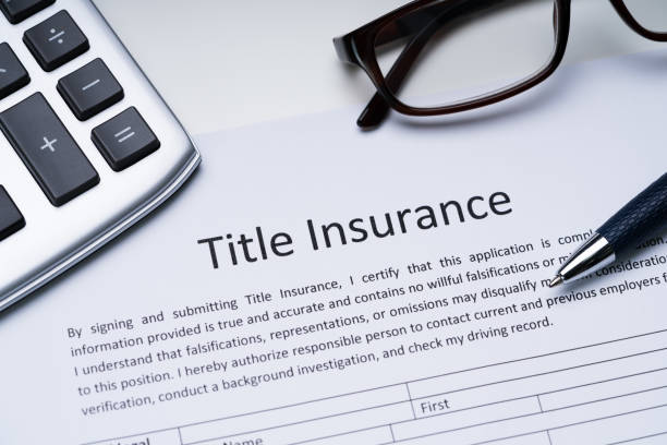 istock Title Insurance Form Over White Desk 1188462599