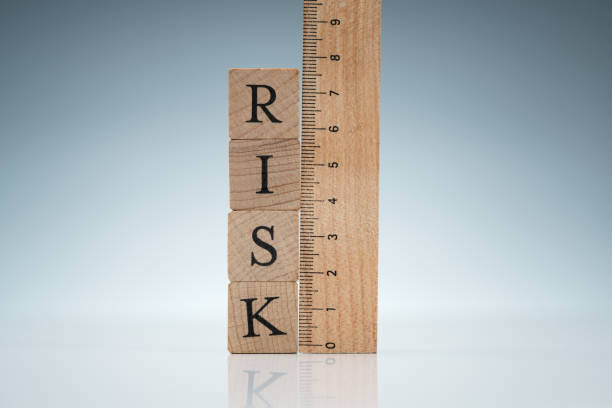 istock Risk Word On Blocks Near The Ruler On Reflective Desk 1188463063