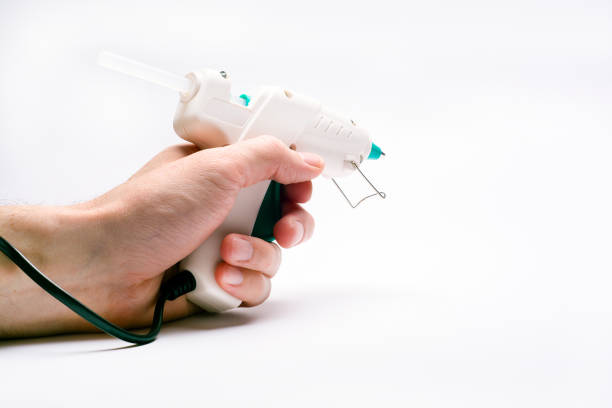 istock glue gun in the hand on white 1188463113