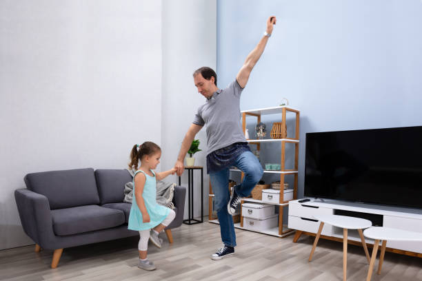 istock Father Dancing With Her Daughter At Home 1188464312