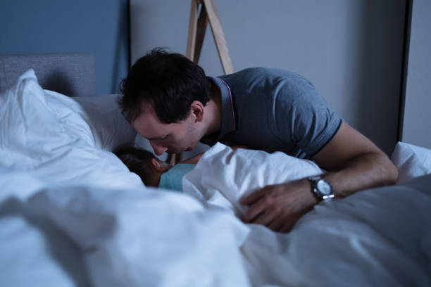 istock Father Kissing Her Daughter On Bed 1188464323