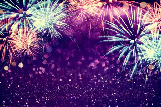Photo of Purple colorful fireworks and bokeh in New Year eve and copy space. Abstract background holiday.