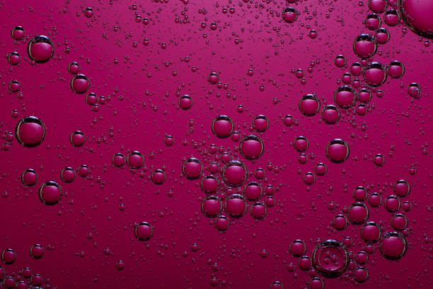 istock oil bubbles on a dark pink background 1188464582