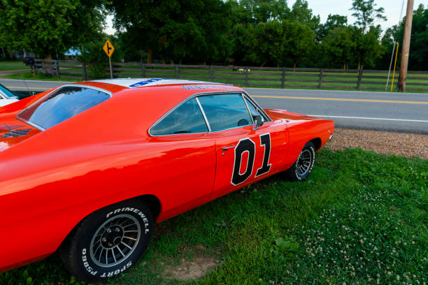 Detail of a replica of the General Lee Charger, from the television series The Dukes of Hazzard, parked along a country road Tennessee, USA - June 26, 2014: Detail of a replica of the General Lee Charger, from the television series The Dukes of Hazzard, parked along a country road in the State of Tennessee. the general lee stock pictures, royalty-free photos & images