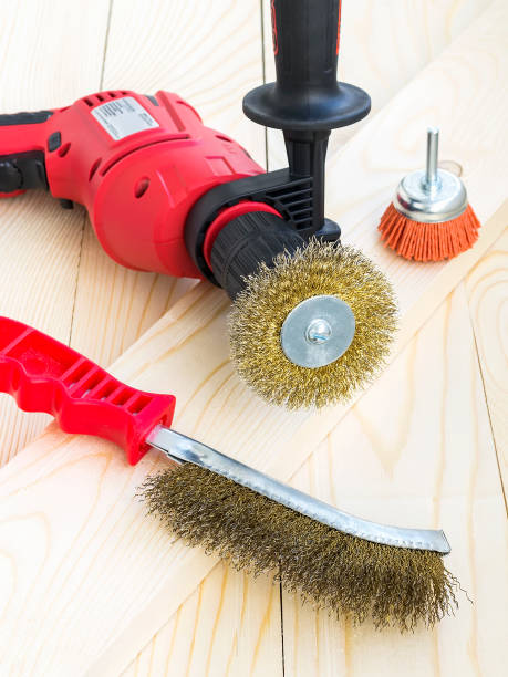istock Drill and abrasive brushes with metal and nylon wire on a wooden surface. Tools for cleaning, polishing and grinding of wood and metal. 1188467272