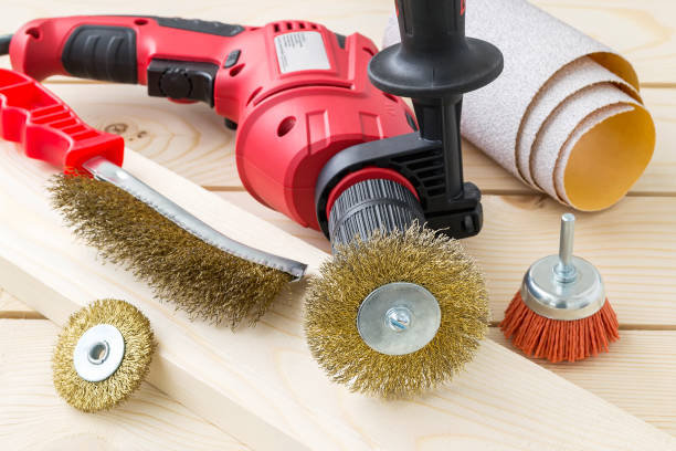 istock Drill, sandpaper and abrasive brushes with metal and nylon wire on a wooden surface. Tools for cleaning, polishing and grinding of wood and metal. 1188467287