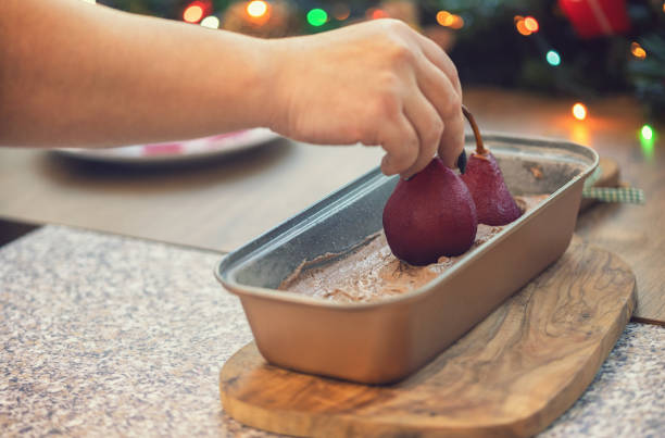 Chef cuts the pears into slices for chocolate cake with pear and nuts. Step by step recipe.