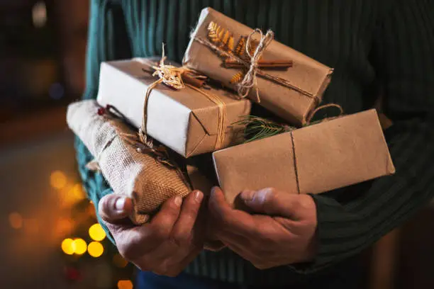 Unrecognizable male hands holding organic Christmas presents.