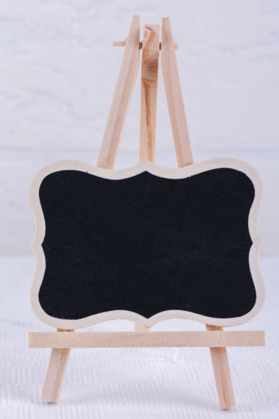 istock Blank chalk board stand mockup on white brick wall background. Empty street signage or blackboard 1188471098