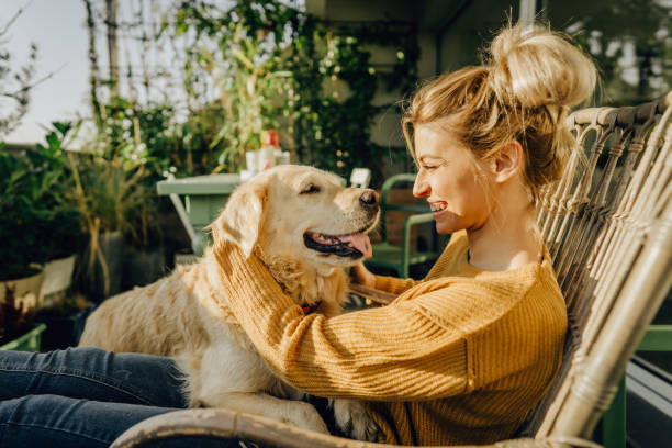 Our moments on the balcony Photo of young woman and her pet enjoying together on the balcony of their loft apartment moment of silence stock pictures, royalty-free photos & images