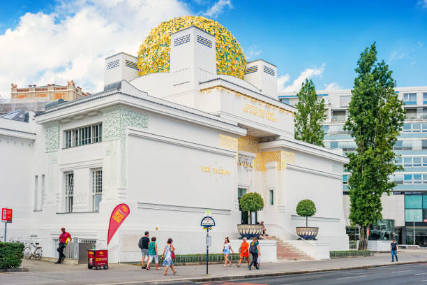 Pedestrians walk past the landmark Secession Building, a Secession style exhibition hall built in 1898, located in downtown Vienna Austria.