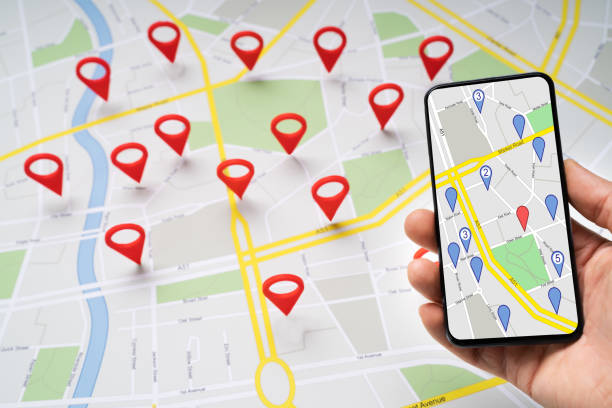istock Person Holding Mobile Phone Against Map With Navigation Icons 1188475437