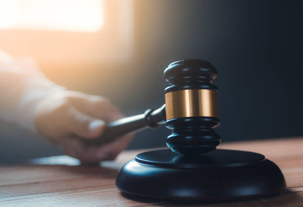 istock part of man's hand while banging the gavel 1188477432