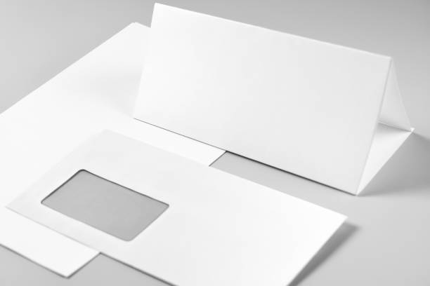 istock Blank Folded Sheet of Paper, Letterhead or Flyer, and Envelope over Stack of Paper 1188478599