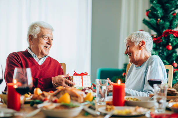 istock Husband and wife exchanging Christmas gifts 1188478802